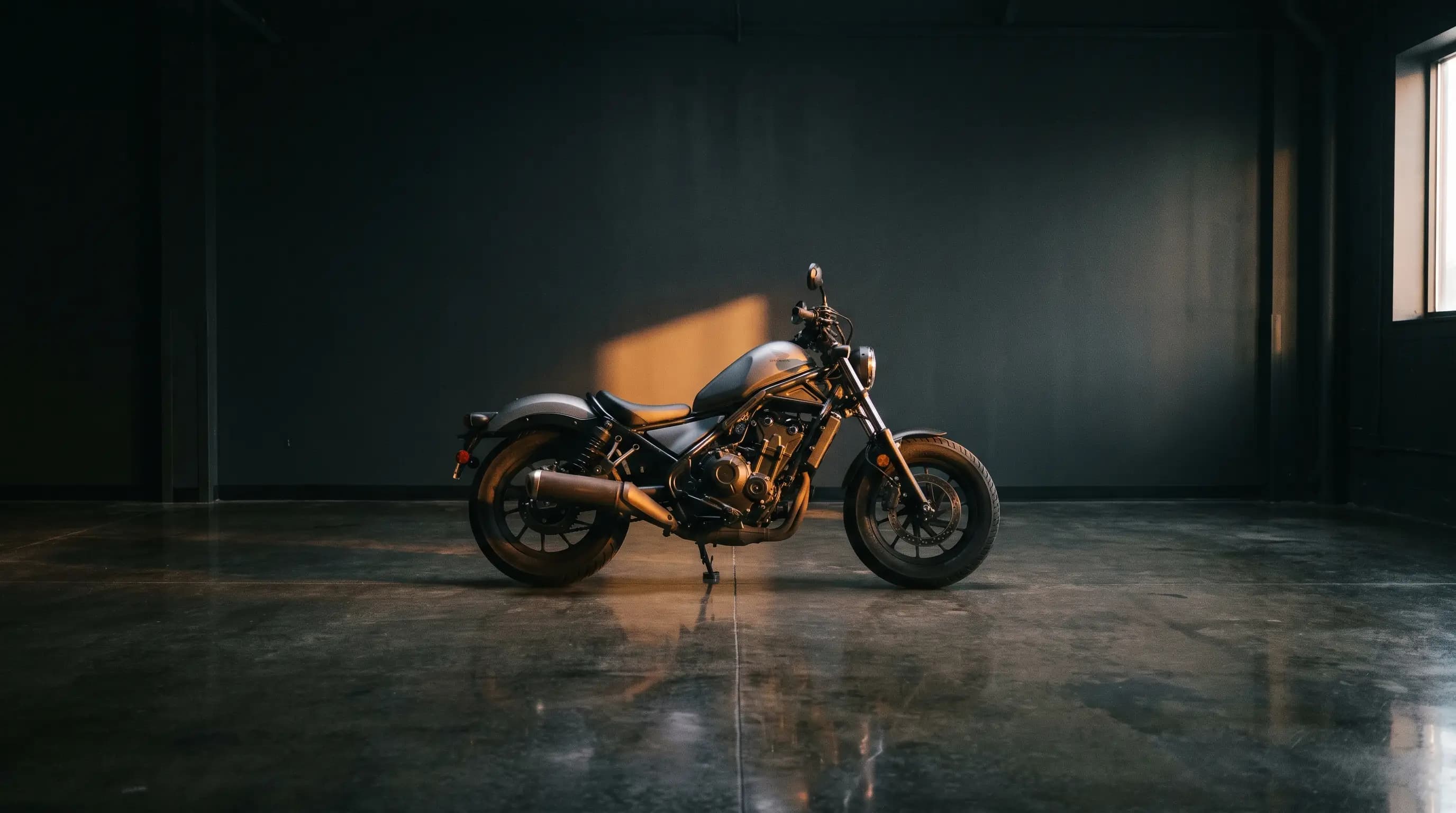 A motorcycle in a showroom under warm light